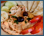 Hummus Platter - Ground chick peas and Tahini sauce served with olives, tomatoes, cucumber, and pita bread